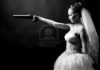 5766354-beauty-young-bride-white-dress-holding-old-gun